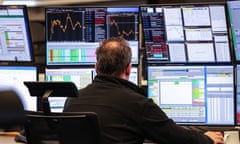 A trader works in front of computer screens in Frankfurt, Germany.