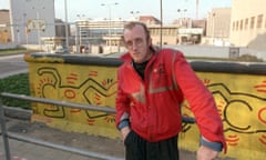 HARING<br>FILE - In this October 1986 file photo, artist Keith Haring stands in front of part of the Berlin Wall that he painted with a crawling baby in Berlin. The Berlin Wall came down in late 1989. Haring died of AIDS Feb. 16, 1990, at age 31.(AP Photo/Elke Bruhn-Hoffmann, File)