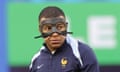 Kylian Mbappé warms up in a mask before France's game with the Netherlands.