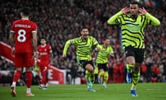 TOPSHOT-FBL-ENG-PR-LIVERPOOL-ARSENAL<br>TOPSHOT - Arsenal's Brazilian defender #06 Gabriel Magalhaes (R) celebrates after scoring his team first goal during the English Premier League football match between Liverpool and Arsenal at Anfield in Liverpool, north west England on December 23, 2023. (Photo by Paul ELLIS / AFP) / RESTRICTED TO EDITORIAL USE. No use with unauthorized audio, video, data, fixture lists, club/league logos or 'live' services. Online in-match use limited to 120 images. An additional 40 images may be used in extra time. No video emulation. Social media in-match use limited to 120 images. An additional 40 images may be used in extra time. No use in betting publications, games or single club/league/player publications. /  (Photo by PAUL ELLIS/AFP via Getty Images)