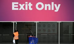 A worker cleans glass doors of the Mobile World Congress in Barcelona. 