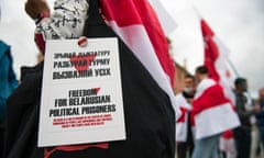 A Belarusian woman holds a placard that says ‘Freedom for Belarusian political prisoners’ during a demonstration in Poland in August.