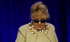 Teena McQueen in sunglasses against blue background at Liberal party conference