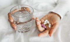 Woman takes daily vitamins with water