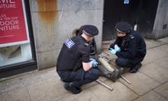 Police officers in Manchester assist a man who is thought have taken spice.