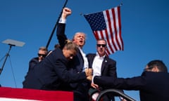 Former President Donald Trump is taken from the stage after the shooting.