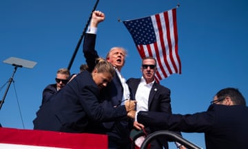 Former president Donald Trump is rushed off stage by secret service personnel after being shot at during a campaign at the Butler Farm Show.