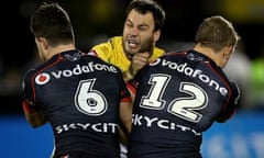 Warriors Chad Townsend (left) and Ryan Hoffman tackle Canberra Raider David Shillington