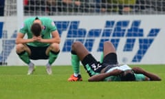 Two Cheltenham players look dejected after losing a game.