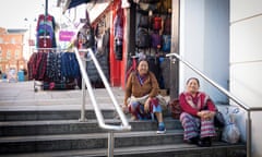 Two women sit on street steps in Aldershot, which forms part of Rushmoor in Hampshire