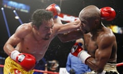 Floyd Mayweather Jr., Manny Pacquiao<br>FILE - In this May 2, 2015 file photo, Manny Pacquiao, left, from the Philippines, trades blows with Floyd Mayweather Jr., during their welterweight title fight in Las Vegas. Pacquiao lost his biggest fight in the ring, but that wont stop him from plotting a bigger comeback - in the political arena that is. Some fans still want a rematch because they felt cheated by the lackluster Pacquiao-Mayweather bout billed by promoters as the Battle for Greatness, though boxing analyst Ed Tolentino calls it the Fiasco of the Century. (AP Photo/John Locher, File)