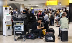 Travellers wait near the British Airways check-in area at Heathrow Airport on 28 August, 2023. 