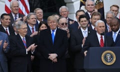 Donald Trump listens as Mike Pence speaks