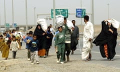 20th anniversary of the Iraq invasion<br>epa10526322 (FILE) - Locals leave the city of Fallujah after an Iraqi car exploded at the second checkpoint in Fallujah, Iraq, 29 April 2004 (reissued 16 March 2023). A US-led coalition launched a military invasion of Iraq on 19 March 2003 following former President George W. Bush and his administration's claims that Iraq had stockpiled weapons of mass destruction. The invasion resulted in a change of political regime and years of political and social instability and crisis. The US withdrew its troops officially from Iraq in summer 2010. EPA/ALI HAIDER ATTENTION: This Image is part of a PHOTO SET *** Local Caption *** 00181475