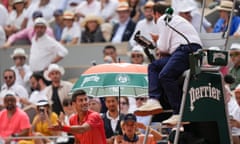 Novak Djokovic argues with the umpire, Damien Dumusois, after being hurried from his seat at the French Open final. 