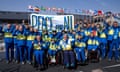 Ukraine athletes raise their fists at a protest.