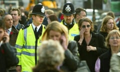 Two British police officers patrol the streets