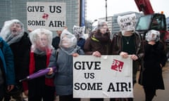 Activists protest for clean air at the European council in Brussels<br>16 Dec 2015, Brussels, Belgium --- Brussels, Belgium. 16th December 2015 -- Activists protest for clean air and for a solution of the dieselgate affair by pretending to be choking with plastic bags over their heads at the European council in Brussels. -- Activists gathered in front of the European council in Brussels to demand clean air. They ask for a solution of the #Dieselgate affair by Volkswagen. They pretended to be choking by putting plastic bags over their heads. --- Image by © Frederik Sadones/Demotix/Corbis