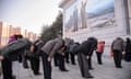 People pay their respects at a mosaic depicting former leaders to mark the 10-year anniversary of the death of Kim Jong-il on 17 December.