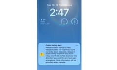 phone screen with 'Public Safety Alert' notification on blue wallpaper