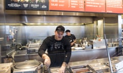 FILE - In this Dec. 15, 2015, file photo, a Chipotle Mexican Grill employee prepares food, in Seattle. After an E. coli outbreak that sickened more than 50 people, Chipotle is changing its cooking methods to prevent the nightmare situation from happening again. (AP Photo/Stephen Brashear, File)