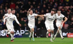 Mark Ricketts (far right) celebrates the winning goal with his teammates.