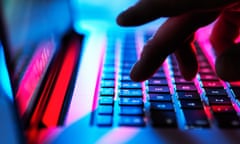 Stock image of a man typing at his laptop computer