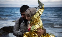 A Syrian couple hug after arriving on the Greek island of Lesbos