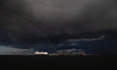 A rainbow appears as a storm builds over the Ichthy's onshore gas processing facility on Middle Arm in Darwin Harbour. For Northern Territory gas project. Photograph by Mike Bowers. Sunday 19th March 2023. Guardian Australia.