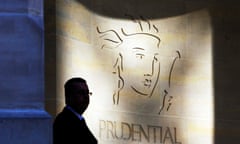 A security guard in front of a Prudential office in London