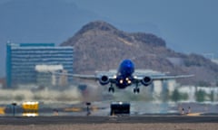 A jet takes flight as heat ripples radiate from the runway at Sky Harbor international airport in Phoenix.