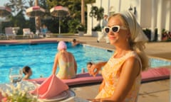 Kristen Wiig by the pool, looking pleased with herself, in Palm Royale.