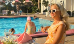 A woman wearing cat-eye sunglasses and a headscarf  sits by a pool in an image taken from the TV show Palm Royale