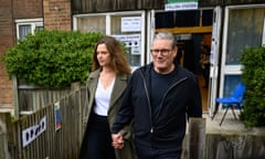 Keir Starmer and his wife Victoria holding hands leaving a polling station