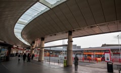 The central bus station, Sunderland – view of quite empty concourse with several people standing around and one bus in background