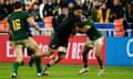 Ardie Savea (centre) crashes through a tackle during the World Cup final