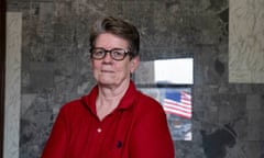 Woman with red shirt and glasses looks at camera