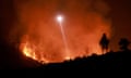 a helicopter flies above a fire