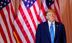 Man in suit in front of American flag