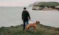 Daniel Payne, who was convicted as part of a drug smuggling conspiracy with four other fishermen on the Isle of Wight in 2011, stands with his dog Drago on the coastal path overlooking Freshwater Bay, near to where the drug parcels were discovered. Payne has always maintained his innocence. Freshwater, Isle of Wight, UK. 20th March 2020.