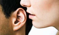 Woman whispering in man's ear