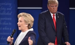 Hillary Clinton speaks into microphone during debate as Donald Trump watches