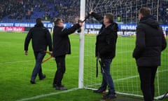 Ground staff remove bicycle locks from the goalposts at the Volksparkstadion in Hamburg.