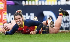 Adelaide’s Anne Hatchard celebrates a goal under Greater Western Sydney’s Alicia Eva at Wigan Oval.