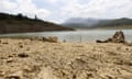 Dried-out ground on the edge of the Gaddara Dam, where water levels have dropped