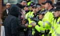 Police hold back Muslim protesters from marching along Belgrave Road in Leicester to avoid clashes with the Hindu community.