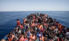 Migrants crowd the deck of a wooden boat off the coast of Libya, May 2015.