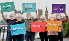 Protesters dressed as Boris Johnson hold placards in central London showing the groups of people that would be affected most by a Tory Brexit budget.