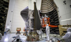 Workers encase Nasa’s Lucy spacecraft inside the Atlas V rocket’s payload fairing in preparation for Saturday’s launch. 