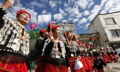 Clad in Kachin traditional costumes, women dance with miniature flags of ethnic rebels as they welcome other ethnic rebels during a nationwide ceasefire conference at the headquarters of KIA in Laiza, a border town of China and Myanmar, Kachin State, Myanmar, Tuesday, Oct. 29, 2013. From 1961 until 1994, the KIA fought a grueling and inconclusive war against the Burmese junta for independence, but now the groups goal is for autonomy within a federal union. The Kachins are a coalition of six tribes whose homeland encompasses territory in Yunnan, China and Northeast India, in addition to Kachin State in Burma. (AP Photo/Khin Maung Win)